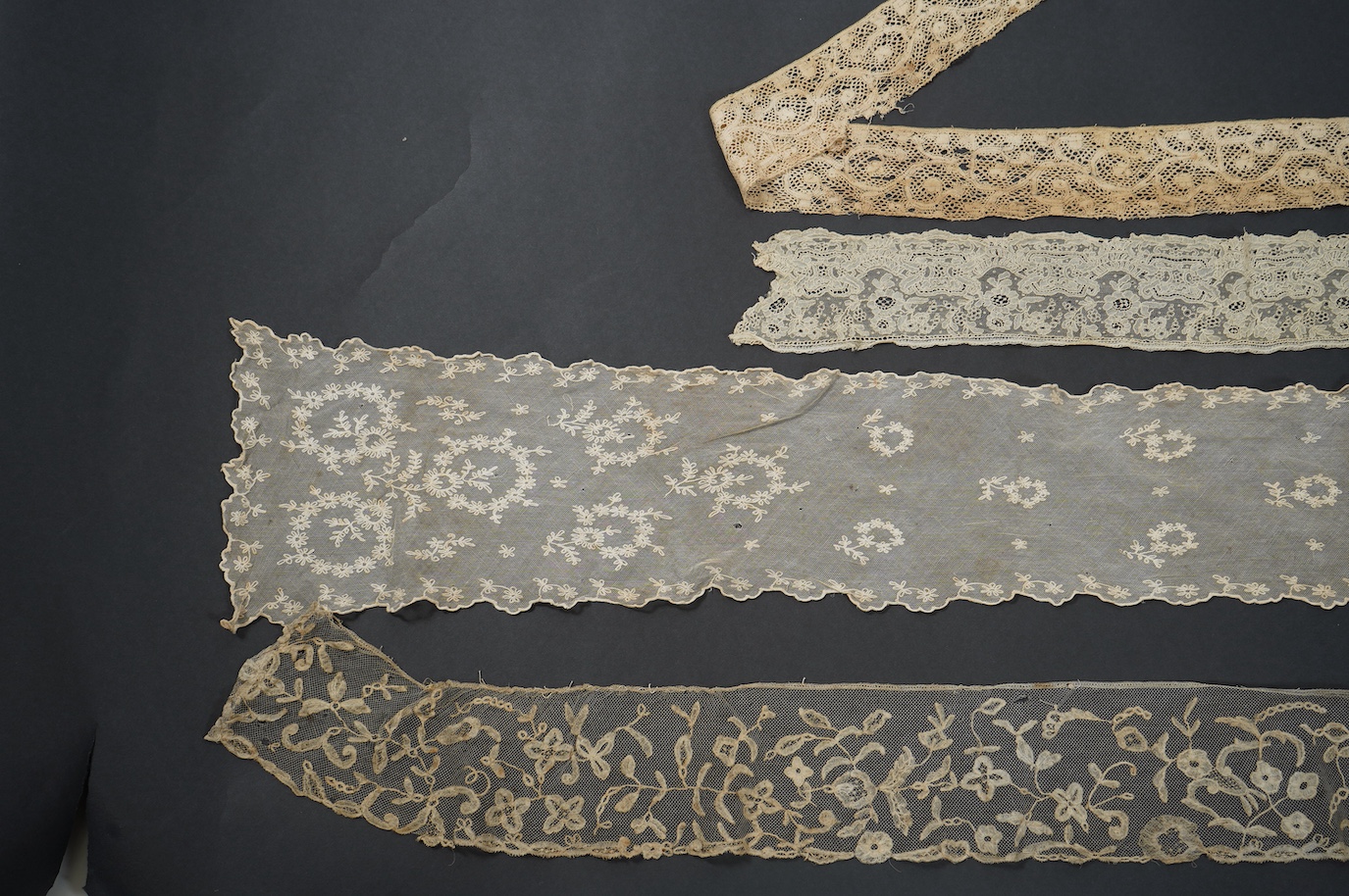 An early 19th bobbin lace length and a Brussels needle lace length, a Brussels bobbin lace wedding hankie and Brussels collar and length of trimming, a needle run collar and similar stole. (7). Brussels bobbin trim 250cm